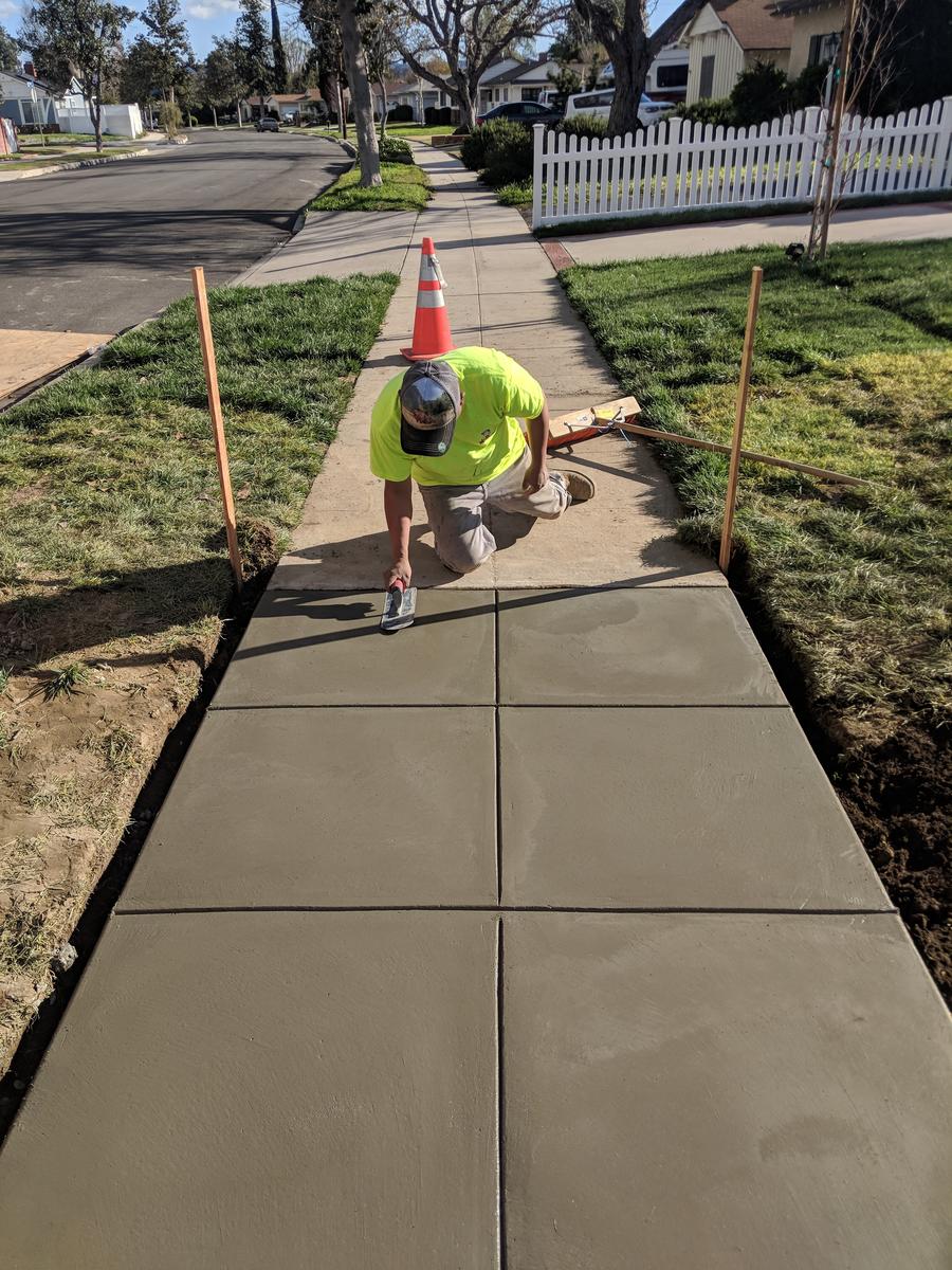 Freshly finished concrete sidewalk restored over a completed BBC Rooter sewer line repair
