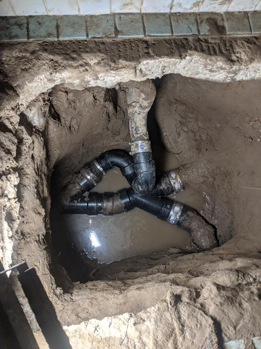 New sewer pipe and fittings installed in an open excavation